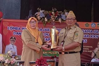 Sekretaris Daerah Banyumas Agus Nur Hadie (kanan) menerima Piala Bergilir Bupati Banyumas dari perwakilan Korwilcam Dinas Pendidikan (Dindik) Kecamatan Purwokerto Timur untuk diperebutkan kembali dalam Lomba Mapsi SD XXV Tingkat Kabupaten Banyumas Tahun 2024 di halaman Kantor Dindik Kabupaten Banyumas, Purwokerto, Banyumas, Jawa Tengah, Senin (29/7/2024). (FOTO: Antara).